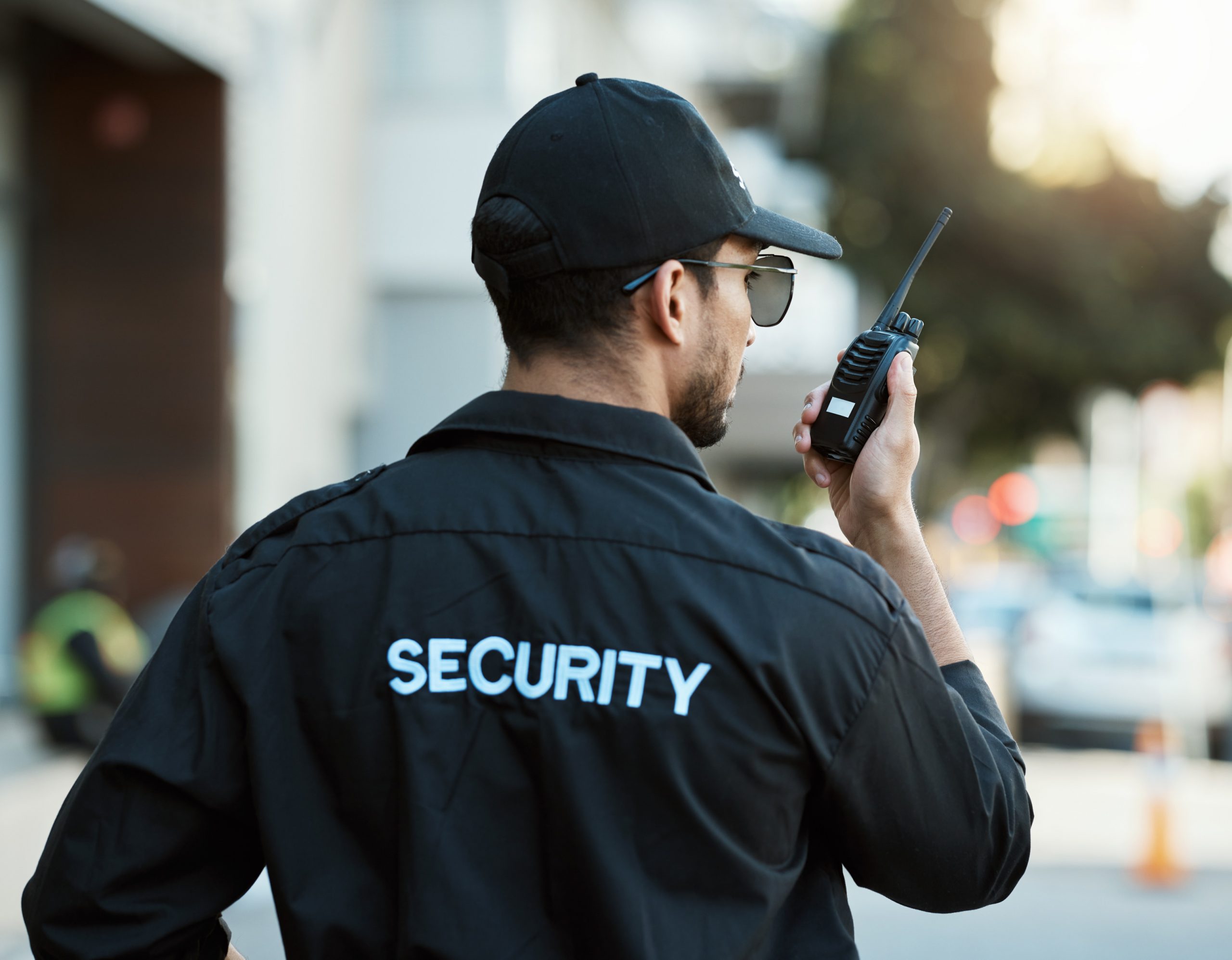 radio-man-security-guard-safety-officer-outdoor-city-road-communication-back-person-with-walkie-talkie-urban-street-report-crime-investigation-surveillance